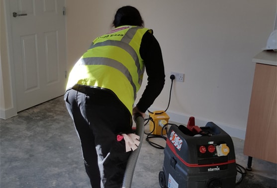 Woman vacuuming the floor