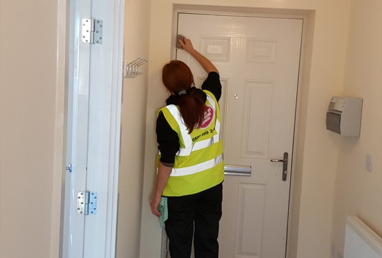 Woman wiping down door frame